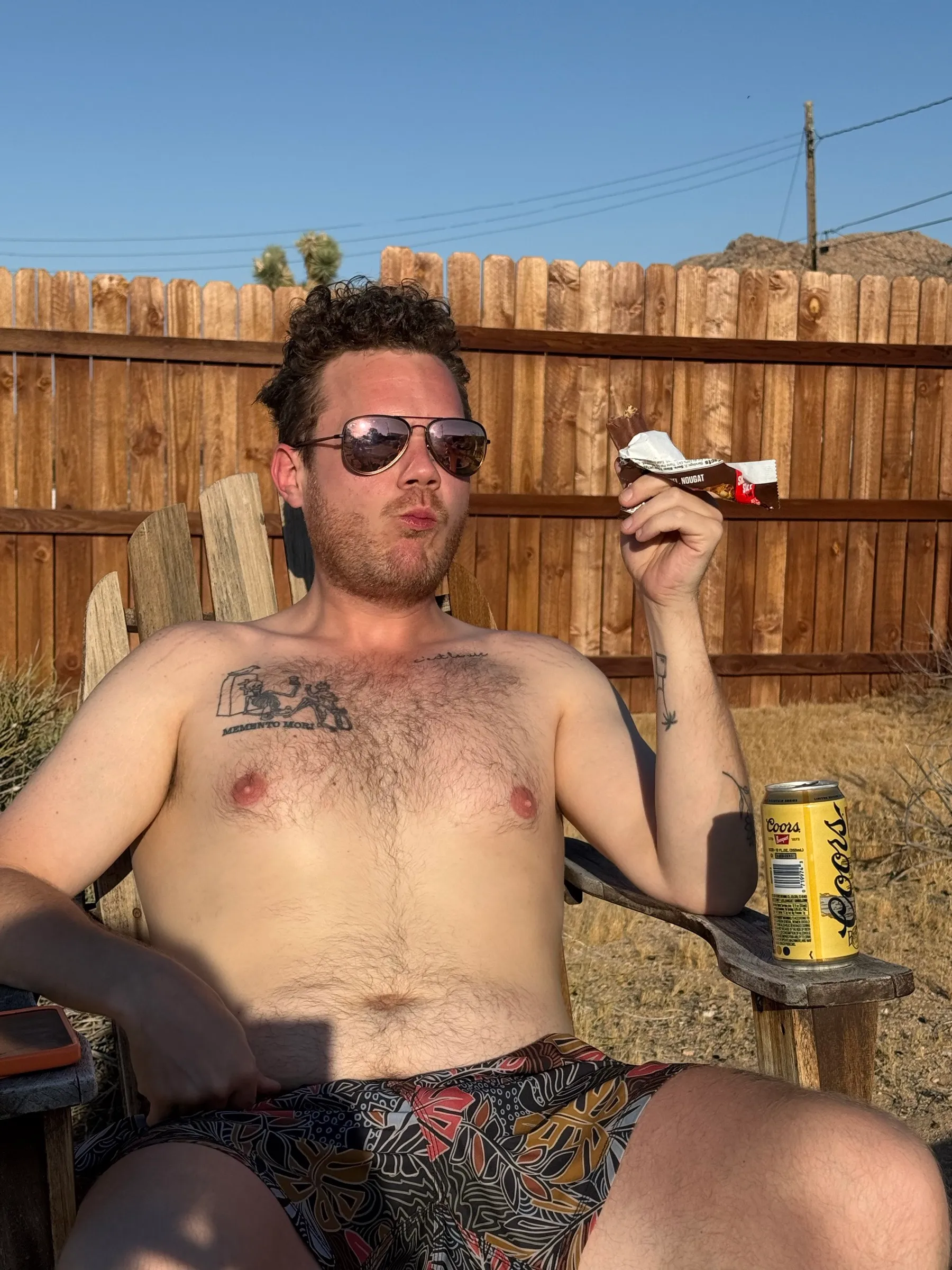 Relaxing in an Adirondack chair with a cold beer and a candy bar