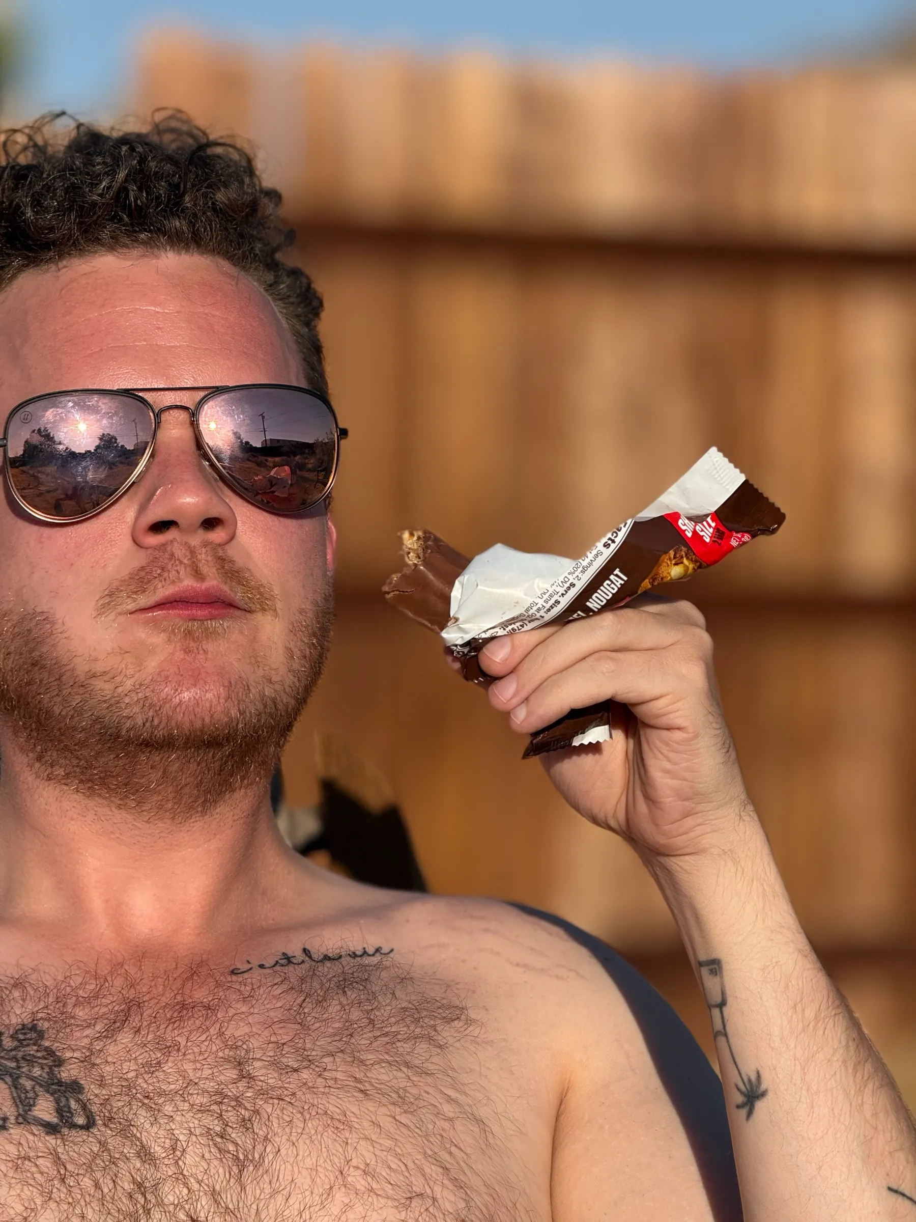 A close up, mid-bite of a candy bar