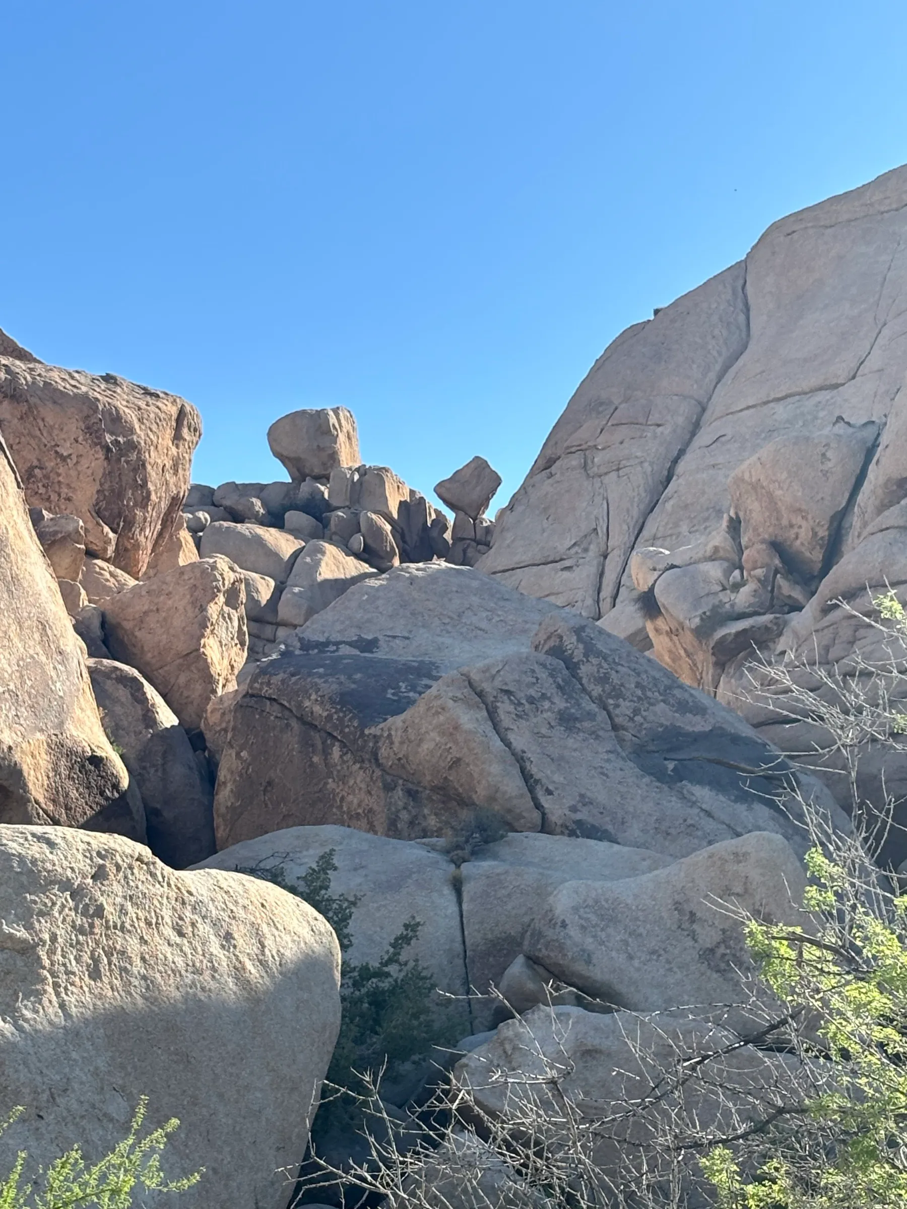 A boulder balanced improbably on top of a rock pile