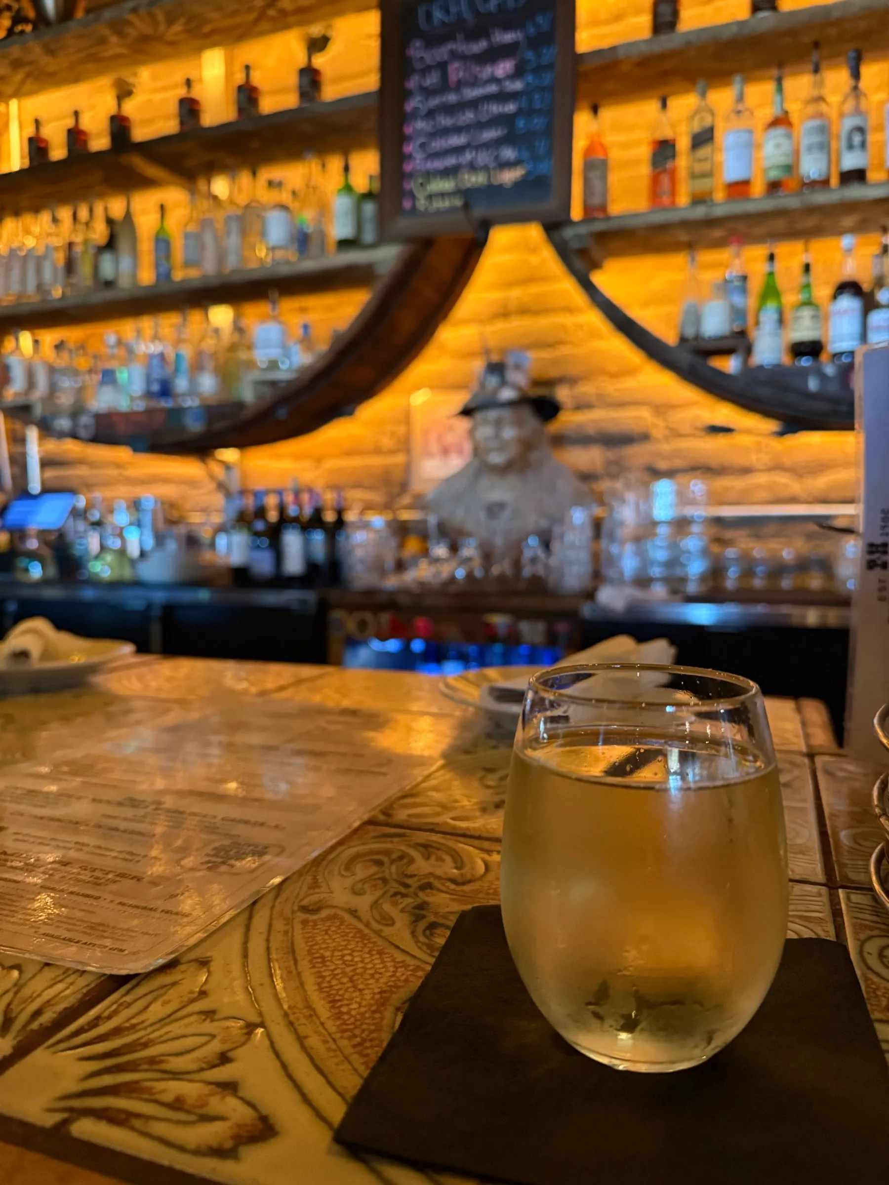 A cold drink at a warmly lit saloon bar